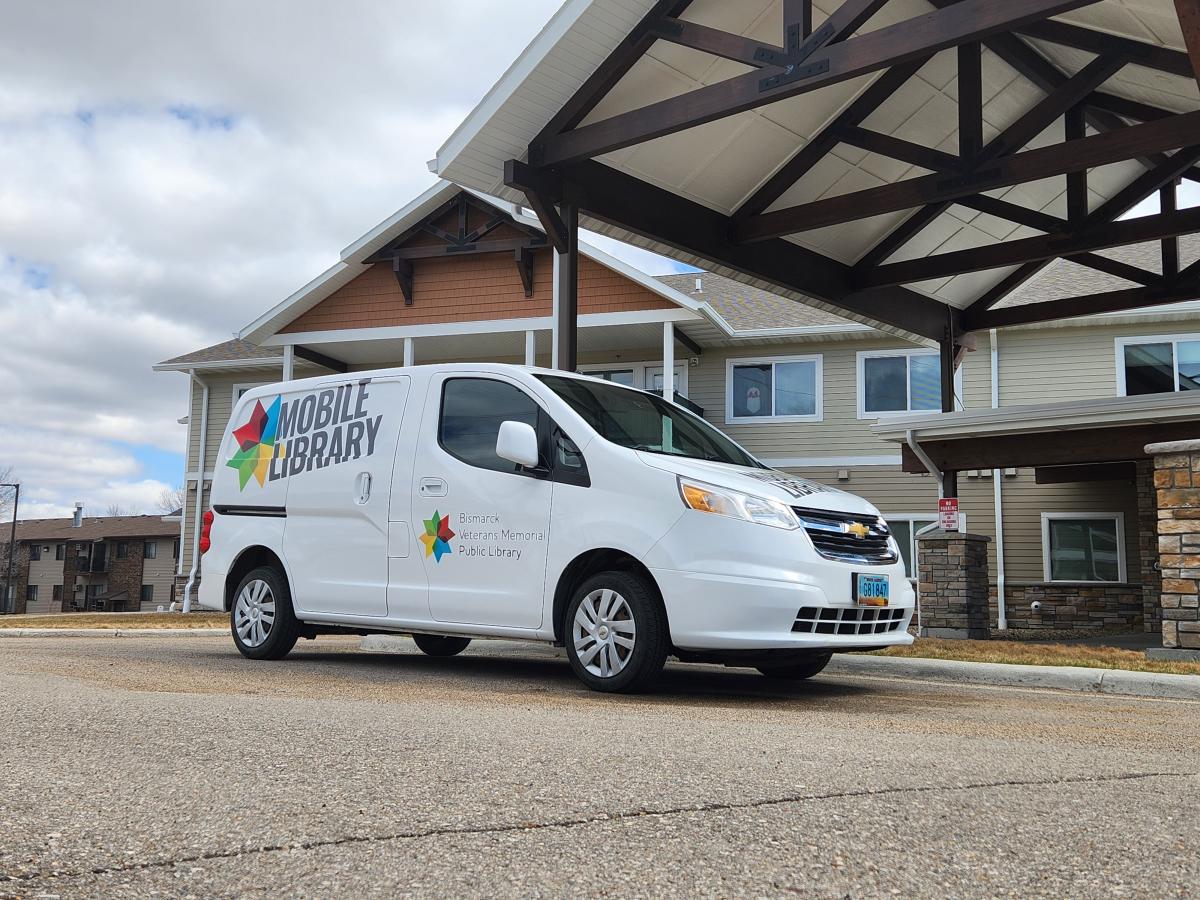 White van parked in front of a building