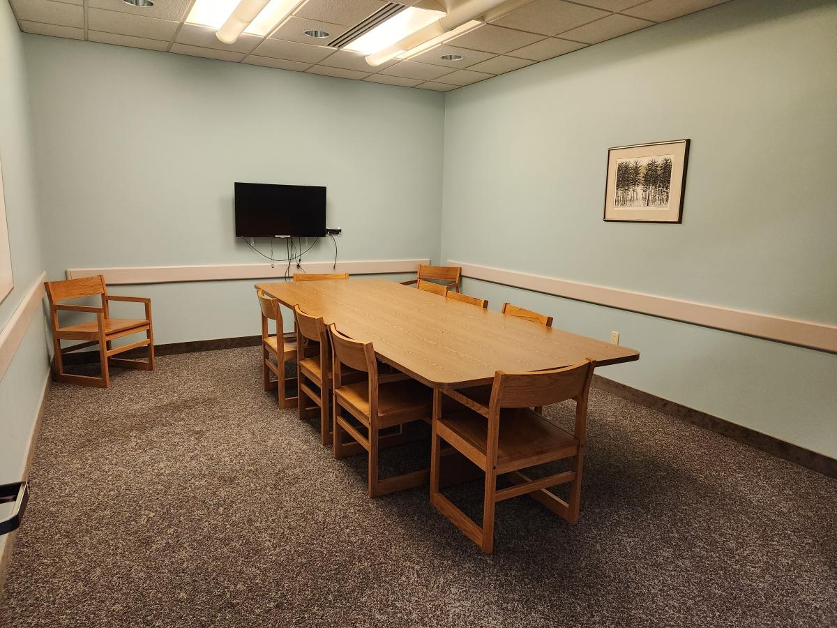 Study room with conference table and chairs and tv monitor