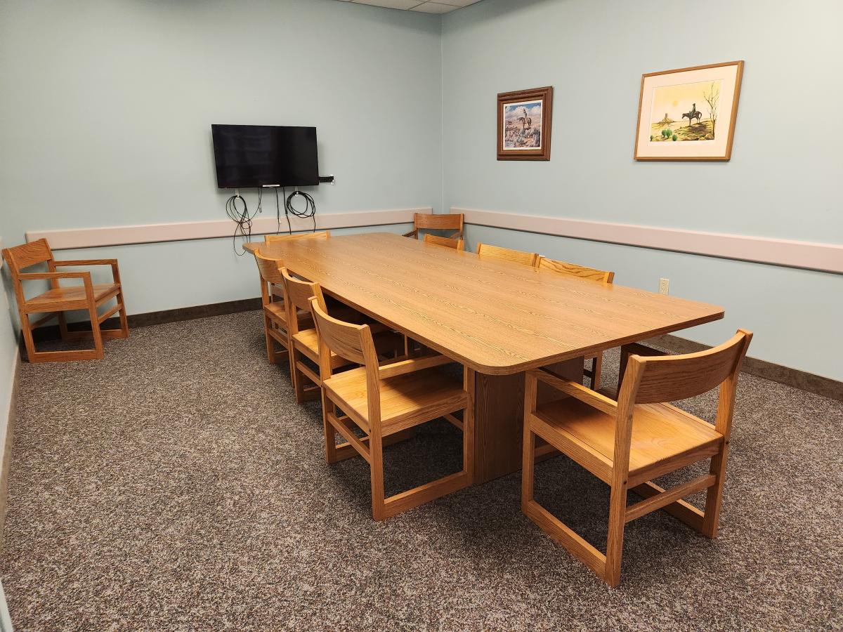 Study room with conference table and chairs and tv monitor